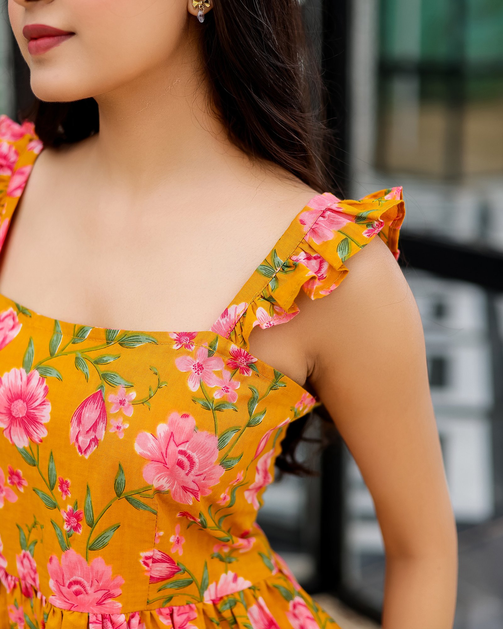 Ruffle strap detail of Bolbo Sunshine Bloom yellow floral coord set showing fine cotton texture and pink flower prints.